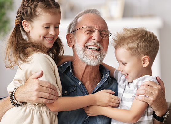 Grandfather hugging his grandkids